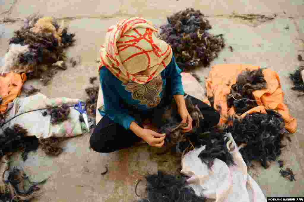 Работніца традыцыйнай фабрыкі вырабу воўны ў Гераце, Афганістан. (AFP/Hoshang Hashimi)