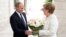 Russian President Vladimir Putin welcomes German Chancellor Angela Merkel in Sochi on May 18.