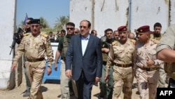 Iraqi Prime Minister Nuri al-Maliki tours military posts on the outskirts of Baghdad on August 6. Can Maliki rise above sectarian divisions to finally unite Iraq?