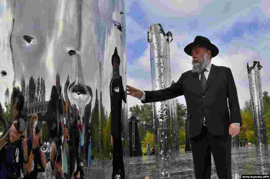 A Jewish man touches an installation opened at Babyn Yar during a ceremony marking the 79th anniversary on September 29 of the beginning of the mass execution of Jews by the Nazis there in September 1941. (AFP/Sergei Supinsky)