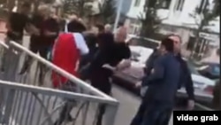 A screen grab from a video showing a number of white men confronting and attacking black students outside a sports field in Tbilisi's Digomi neighborhood on April 8.