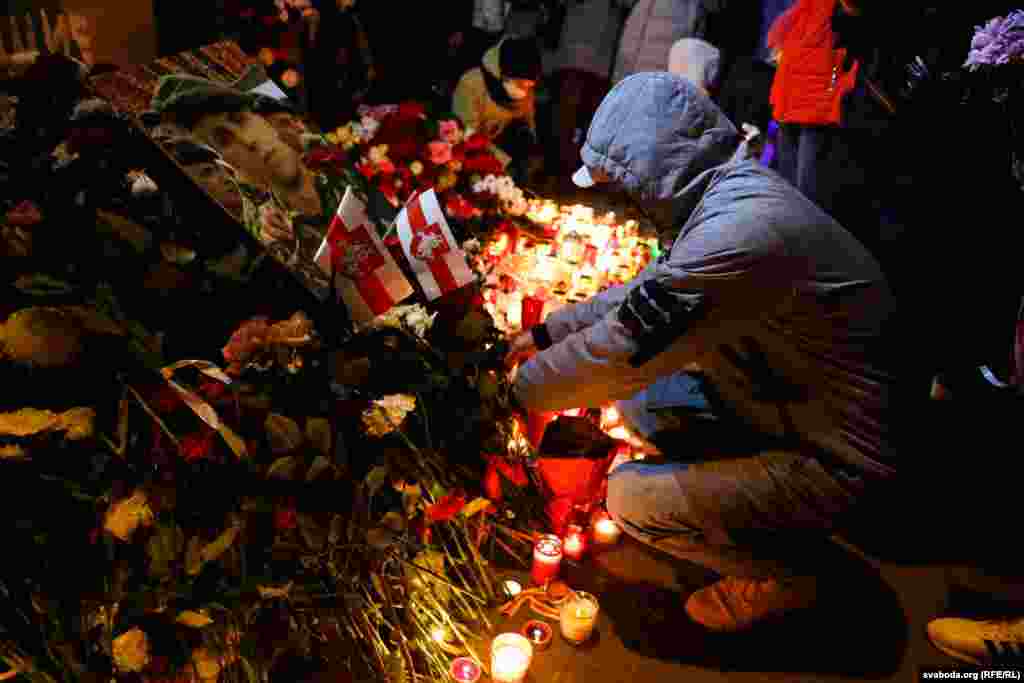 People lay flowers to pay tribute to Raman Bandarenka in a courtyard that has been dubbed the &quot;Square of Changes&quot; in Minsk on November 12.