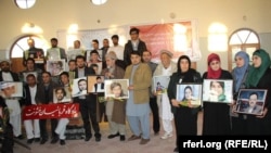 Afghan journalists hold the pictures colleagues killed in recent years (file photo, November 2014)