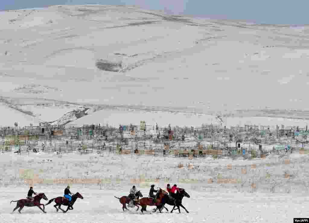 Kyrgyz riders play the traditional Central Asian sport of Kok-boru, know also as Buzkashi or Ulak Tartis ("goat grabbing"), near the village of Besh-Kungey, some 20 kilometers from Bishkek. (AFP/Vyacheslav Oseledko)