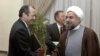 File Photo:Iran's top nuclear negotiator and secretary of the Supreme National Security Council Hasan Rouhani, right, shakes hands with British ambassador to Iran Richard Dalton, in front of German ambassador Paul von Maltzahn at the Saadabad palace in Tehran, Iran,