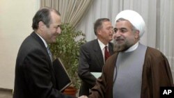 File Photo:Iran's top nuclear negotiator and secretary of the Supreme National Security Council Hasan Rouhani, right, shakes hands with British ambassador to Iran Richard Dalton, in front of German ambassador Paul von Maltzahn at the Saadabad palace in Tehran, Iran,