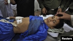 Medics tend to a boy, who was injured in the bombing
