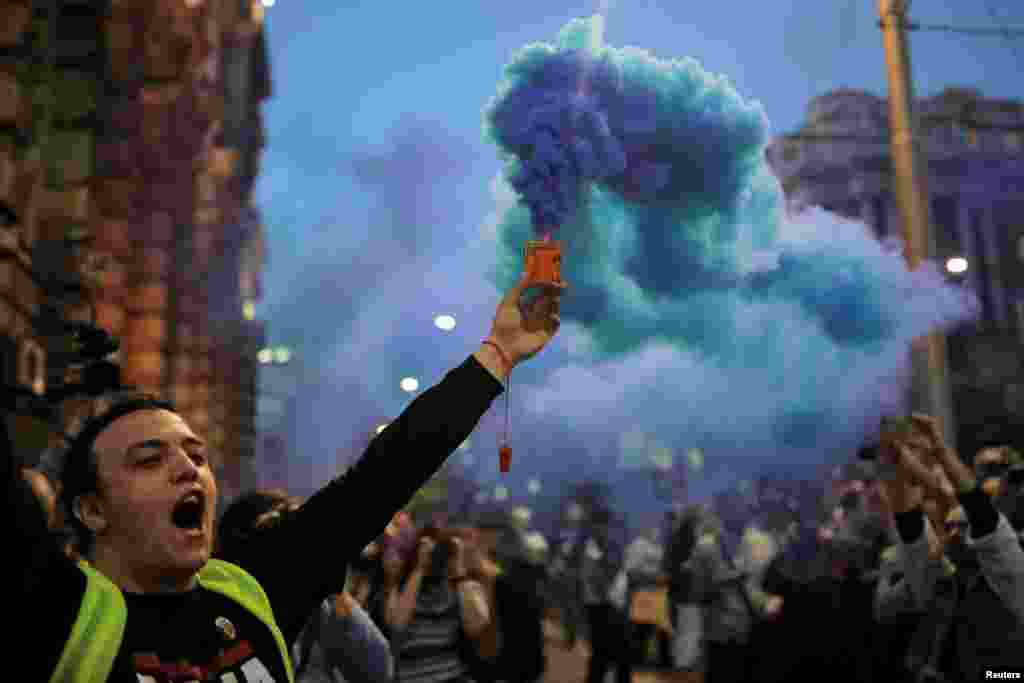 A protester lights a flare during a protest against Prime Minister Aleksandar Vucic's government in Belgrade, Serbia. (Reuters/Marko Djurica)