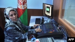 An Afghan female journalist works in the studio of Shahrzad, a women's radio station, in Herat.