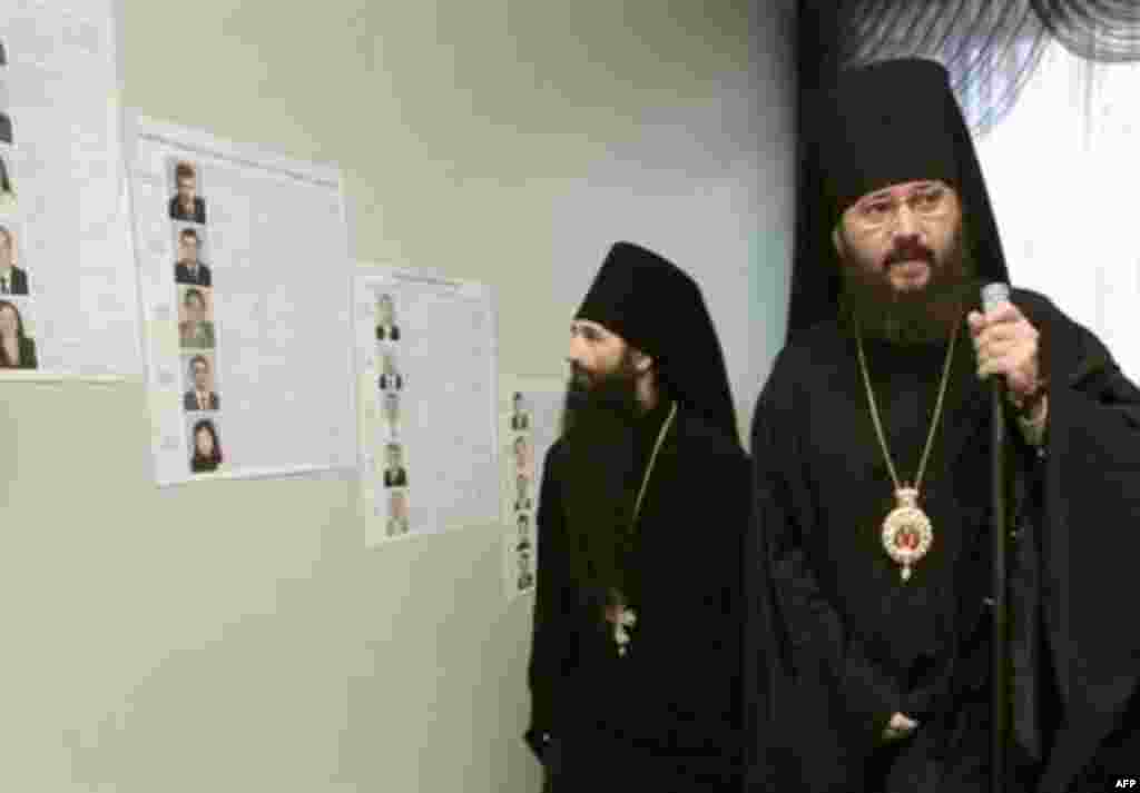 Orthodox priests consult candidate lists in the capital