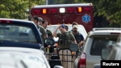 Heavily armed policemen walk from the Washington Navy Yard after the shooting on September 16.