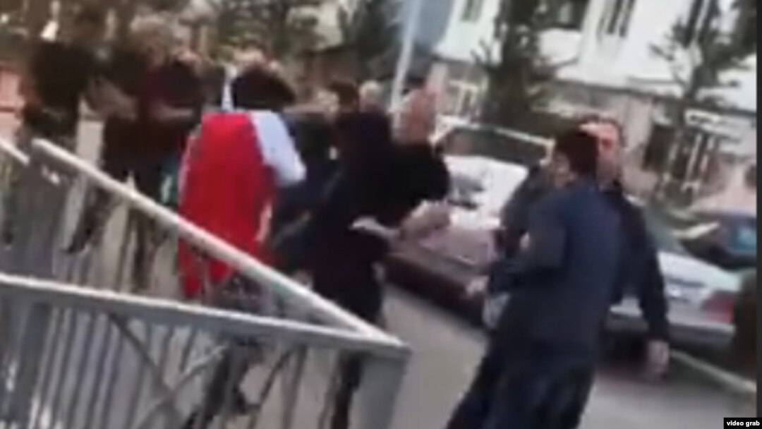 A screen grab from a video showing a number of white men confronting and attacking black students outside a sports field in Tbilisi's Digomi neighborhood on April 8.