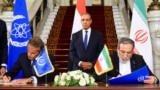 Iranian Foreign Minister Abbas Araqchi (right) and Director-General of the International Atomic Energy Agency Rafael Grossi (left) sign an agreement to open the way for resuming cooperation, at Tahrir Palace in Cairo, on September 9.