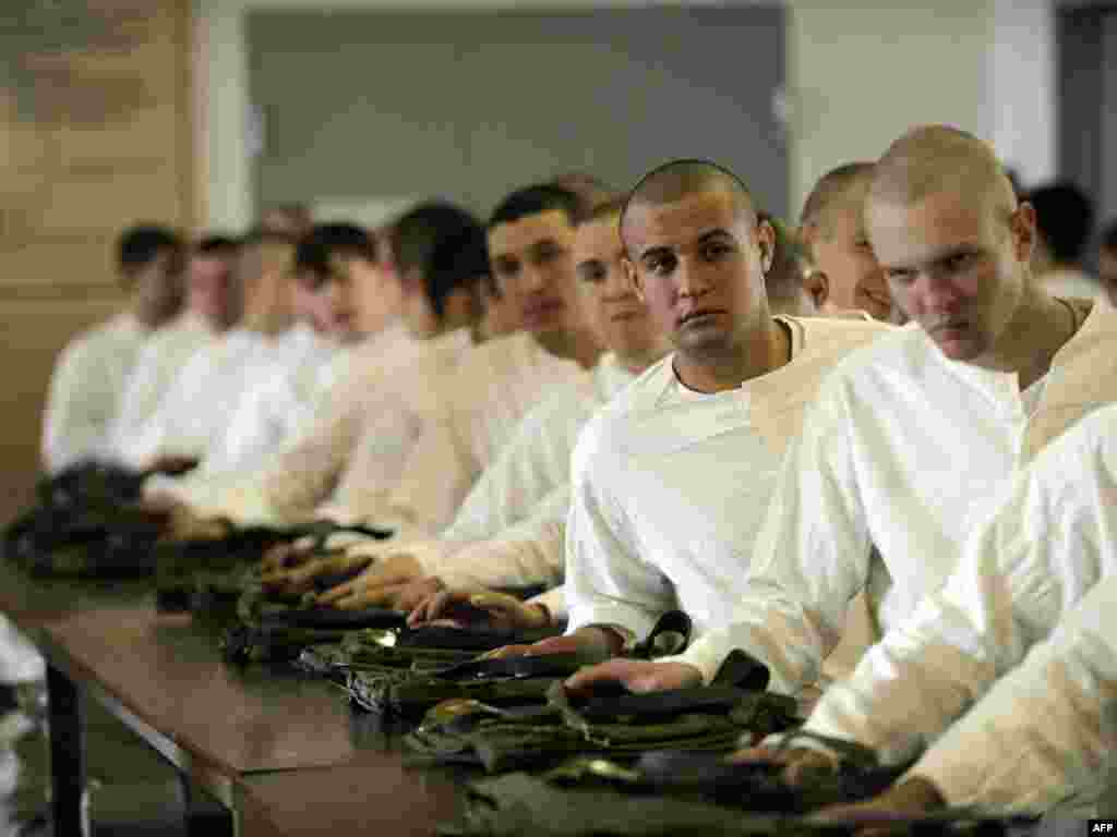 Russian conscripts get their military uniforms at a registration and enlistment office in the southern city of Krasnodar. Some 135,800 young people should be drafted during the 2011 autumn conscription. (Photo for AFP by Mikhail Mordasov)