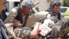 A wounded employee of the National Directorate of Security (NDS), Afghan spy service is brought on a stretcher to a hospital after a car bomb exploded in the city of Aybak, in the northern Samangan Province on July 13.