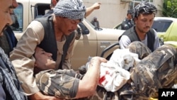 A wounded employee of the National Directorate of Security (NDS), Afghan spy service is brought on a stretcher to a hospital after a car bomb exploded in the city of Aybak, in the northern Samangan Province on July 13.