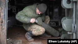 A Ukrainian soldier prepares to fire a 155 mm self-propelled gun toward Russian positions at the front line near Kreminna on January 28.