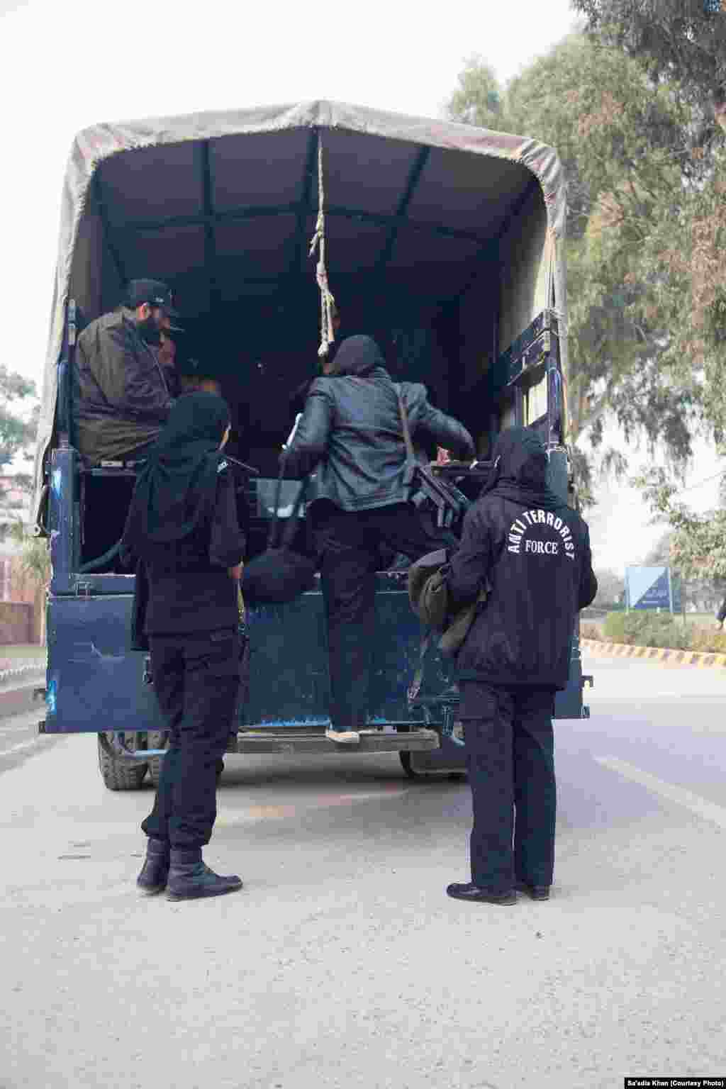 Female commandos boarding a police truck alongside their male counterparts.