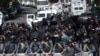 Riot police are deployed on Marshal Bagramian Avenue leading to the parliament building in Yerevan on April 17.