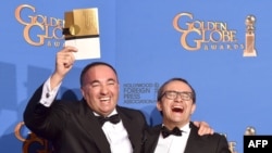 Writer/producer Aleksandr Rodnyansky (left) and director Andrei Zvyagintsev, winners of Best Foreign Language Film for Leviathan, pose in the press room during the 72nd Annual Golden Globe Awards at The Beverly Hilton Hotel on January 11.