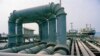 This is the jetty on Kharg Island, Iran, seen, July 1971, where oil is distributed from four major pipes, leading from the tank farm to the jetty, to individual pipes for each of ten landings that can accommodate as many as 10 ships at once, loading them 