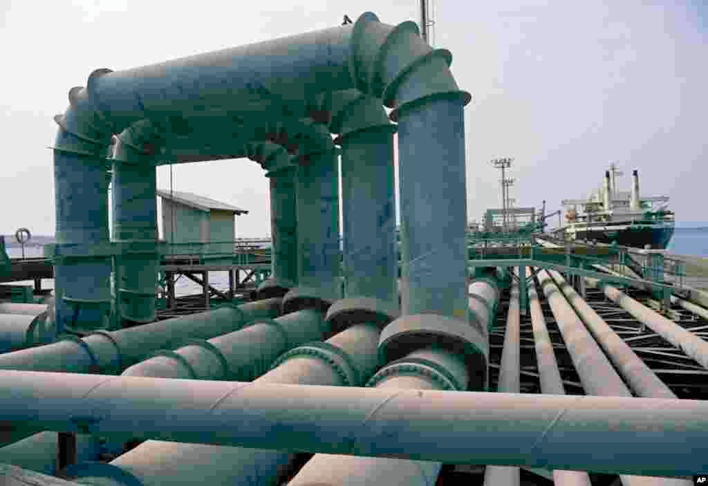 This is the jetty on Kharg Island, Iran, seen, July 1971, where oil is distributed from four major pipes, leading from the tank farm to the jetty, to individual pipes for each of ten landings that can accommodate as many as 10 ships at once, loading them 