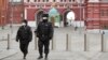 Russian police officers patrol a deserted Red Square in Moscow, which went into lockdown on March 30. 