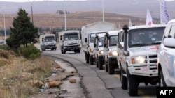Syrian Red Crescent aid convoys carrying food, medicine, and blankets leave the capital, Damascus, as they head to the besieged town of Madaya on January 11.