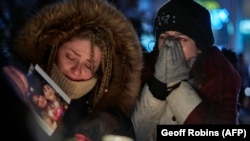 Mourners in Ontario, Canada, weep during a vigil for the victims of Ukrainian Airlines Flight PS752, which was shot down by Iran in 2020, killing all 176 people on board. 