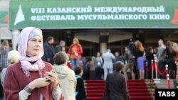 People gather outside a cinema during the International Festival of Muslim Cinema in Kazan.