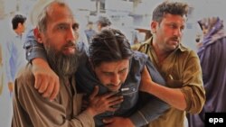 A man who was injured in an earthquake is rushed for medical treatment at a hospital in Peshawar, Pakistan, on April 10. 