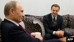 Russia's then-prime minister, Vladimir Putin (left), speaks with U.S. actor Leonardo DiCaprio in St. Petersburg in November 2010, after a concert to mark the International Tiger Conservation Forum.