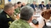 Ukrainian President Petro Poroshenko (third from right) chairs a meeting with members of the National Security Council in Kyiv on November 26.