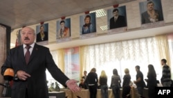 Belarus President Alyaksandr Lukashenka speaks to journalists after casting a ballot in Minsk in the September 23 voting.