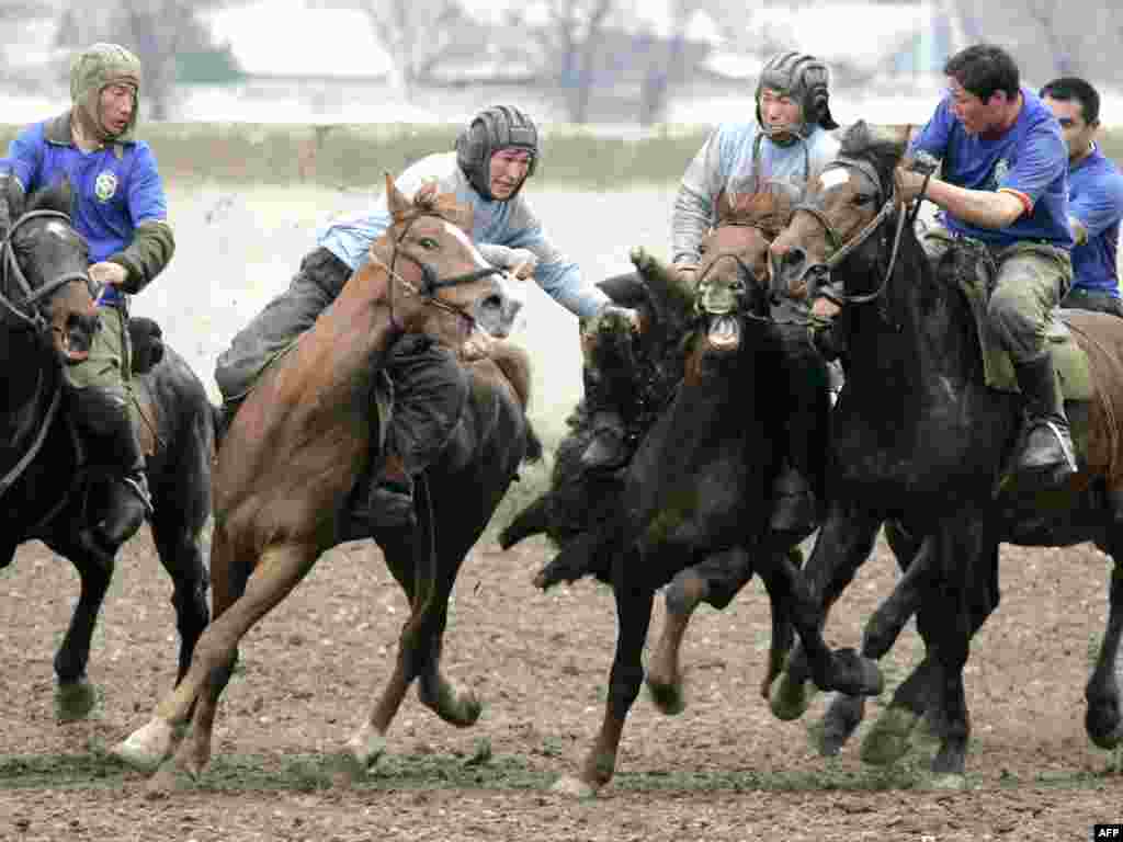 Mounted Kyrgyz men play the traditional central Asian sport of Kok-Boru in Bishkek on March 24, 2009 to mark the Kyrgyzstan's Revolution Day holiday. Kyrgyzstan celebrated the 4th anniversary of the 2005 political revolution. 