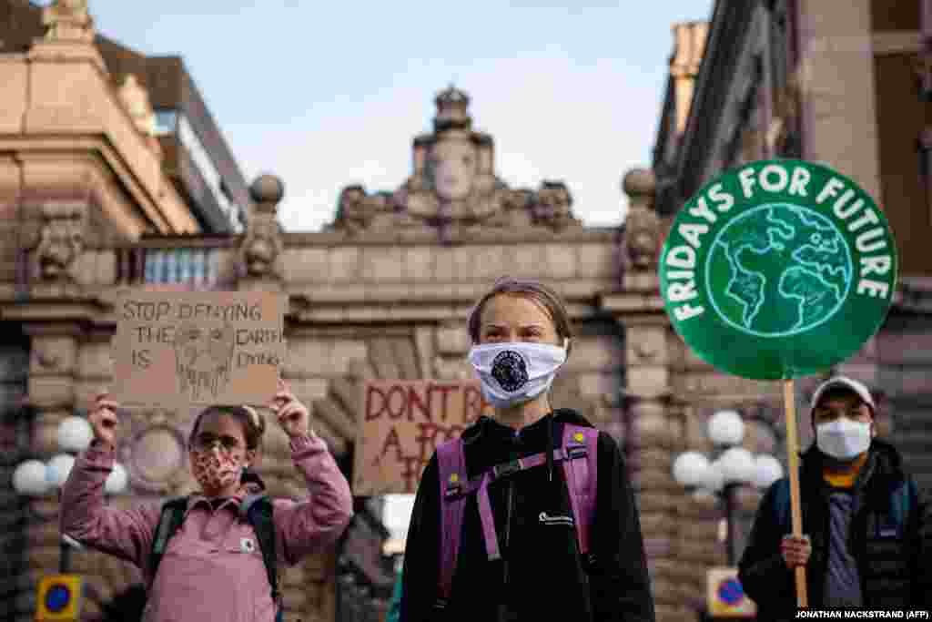 Swedish climate activist Greta Thunberg (C) takes part in a Fridays For Future protest in front of the Swedish Parliament (Riksdagen) in Stockholm on September 25, 2020. She said in a tweet on Thursday that the strikers will &quot;be back next week, next month and next year. For as long as it takes.&quot;