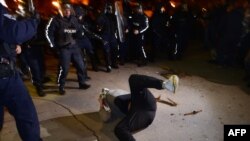 Riot police clash with demonstrators during a protest in front of the parliament in Sofia.