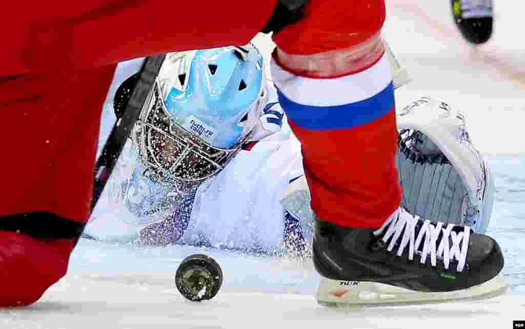 Slovenia's goalkeeper Robert Kristan in action during an ice hockey group match with Russia, who won the game 5-2. 
