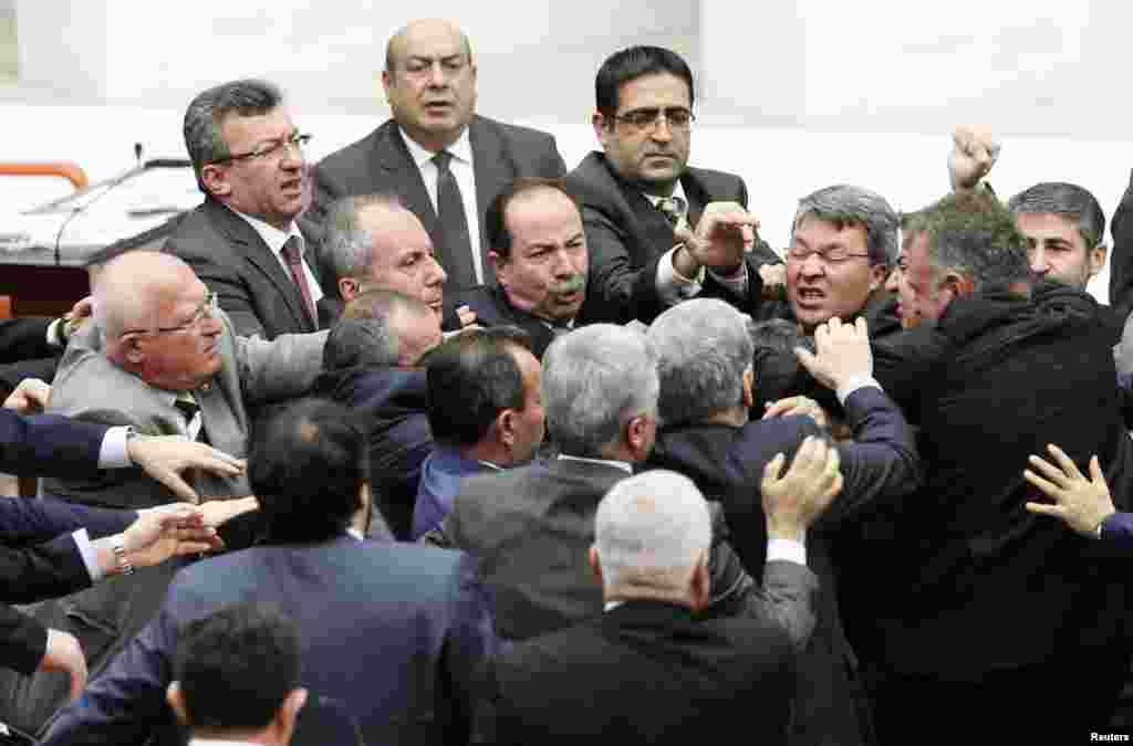Turkish lawmakers from the ruling Justice and Development Party and the main opposition Republican People's Party scuffle at a parliamentary session in Ankara. (Reuters/Stringer)