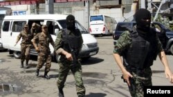  Members of the SNB get out of a minivan during an operation outside the capital, Tashkent, in June 2015.