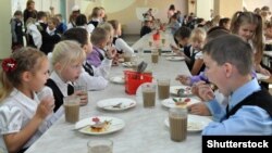 Russia - a child eats in the dining room