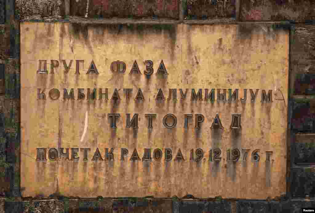 A plaque reads: "Second phase, aluminium factory, Titograd [the former name of Podgorica], work started 19.12.1976."