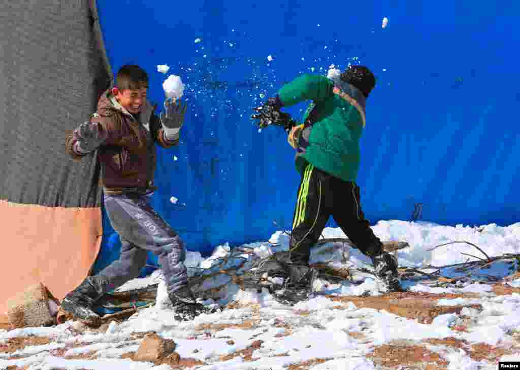 Displaced children who fled from Islamic State militants play with snow at a camp in Duhok, Iraq. (Reuters/Ari Jalal)