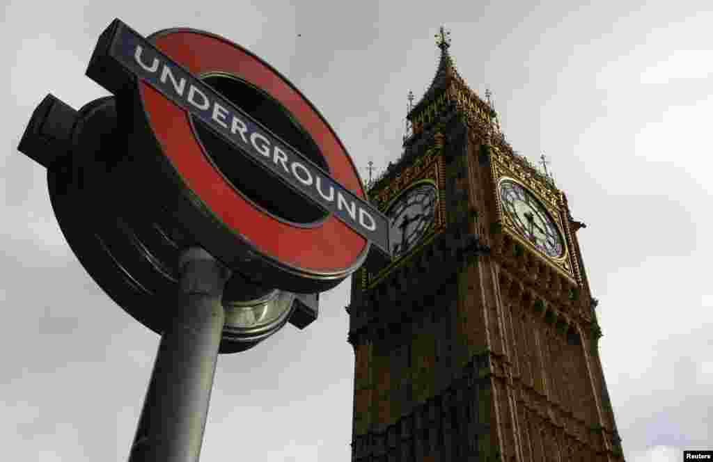 The London Underground&#39;s iconic sign appears in front of the Big Ben clock tower in central London.