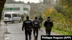 Policemen spread around the "Centre Zahra France" religious association in Grande Synthe during an operation of "terrorism prevention", near Dunkirk, October 2, 2018