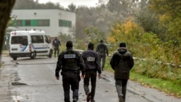 Policemen spread around the "Centre Zahra France" religious association in Grande Synthe during an operation of "terrorism prevention", near Dunkirk, October 2, 2018