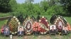 Flowers and photos adorn the graves of priests killed in Sl0vyansk, Ukraine.
