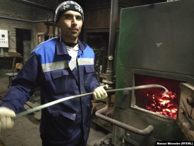 Tajik-born migrant Nazim Soliev at his job as a stoker for a school in Rozhdestveno, Russia