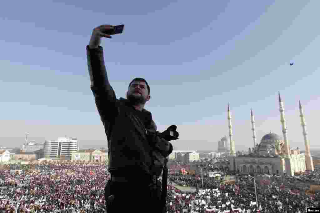 A man takes a selfie as hundreds of thousands of Chechens participated in a rally in the capital, Grozny, to protest against satirical cartoons depicting the Prophet Muhammad. (Reuters/Eduard Korniyenko)