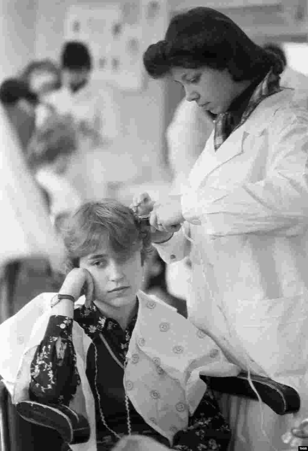 Students practice their craft at a hairdressers vocational school in 1982.